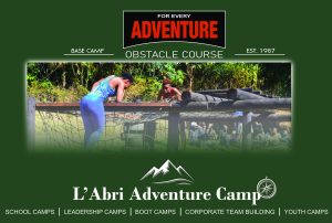 Participants navigating the cargo net wooden obstacle course at L'Abri Adventure Camp in Karkloof