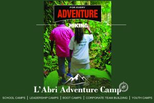 Hikers walking along a lush forest trail at L'Abri Adventure Camp in the Karkloof Midlands