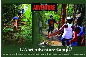 Campers trekking through forest bush trails and climbing wooden woodland steps at L'Abri Adventure Camp