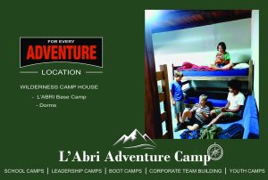Campers relaxing on wooden bunk beds inside the Wilderness Camp House dorms at L'Abri